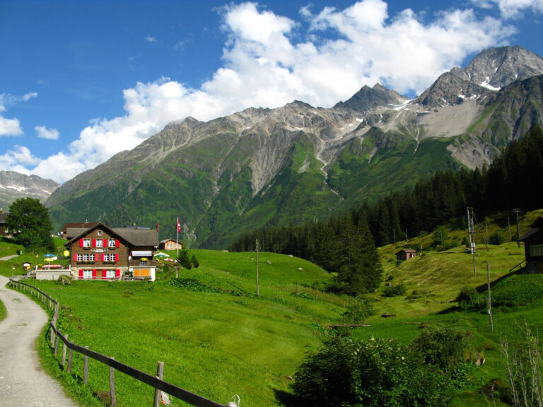 Traditional Swiss village in the Alps with wooden chalets and flowers