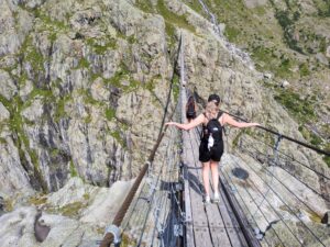 Suspension bridge swaying over the deep glacier valley